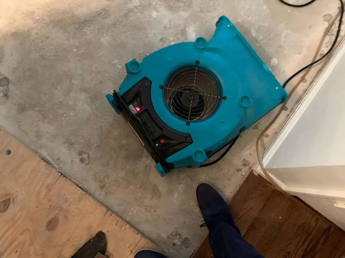 Air mover drying subfloor during Commercial Water Damage Restoration in Rio del Mar